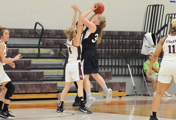 Jade Mosier goes up for a contested shot against a defending player.
