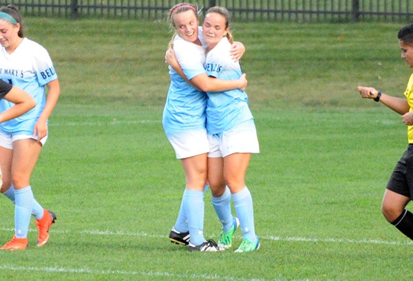 Maya Cole (left) hugs Emily Stross (right) after Stross scored her first collegiate goal.